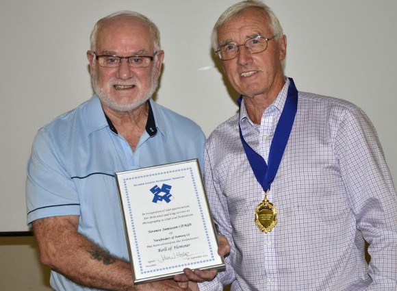 Terry Jamieson of Romsey Viewfiners (left) receives his Roll of Honour from John Hodge (right).